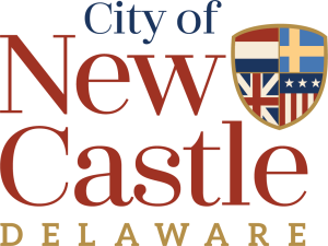 Logo for City of New Castle, Delaware, featuring the wordmark and a heraldic shield on the right.